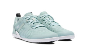 A pair of light blue Prio Women's athletic sneakers from Xero Shoes, featuring white soles and mesh uppers, is shown at a slight angle on a plain white background. The brand name "Xero" appears on the tongue and side.